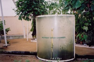 Nutrient chamber where roots are sprayed with nutrient as they pass through.